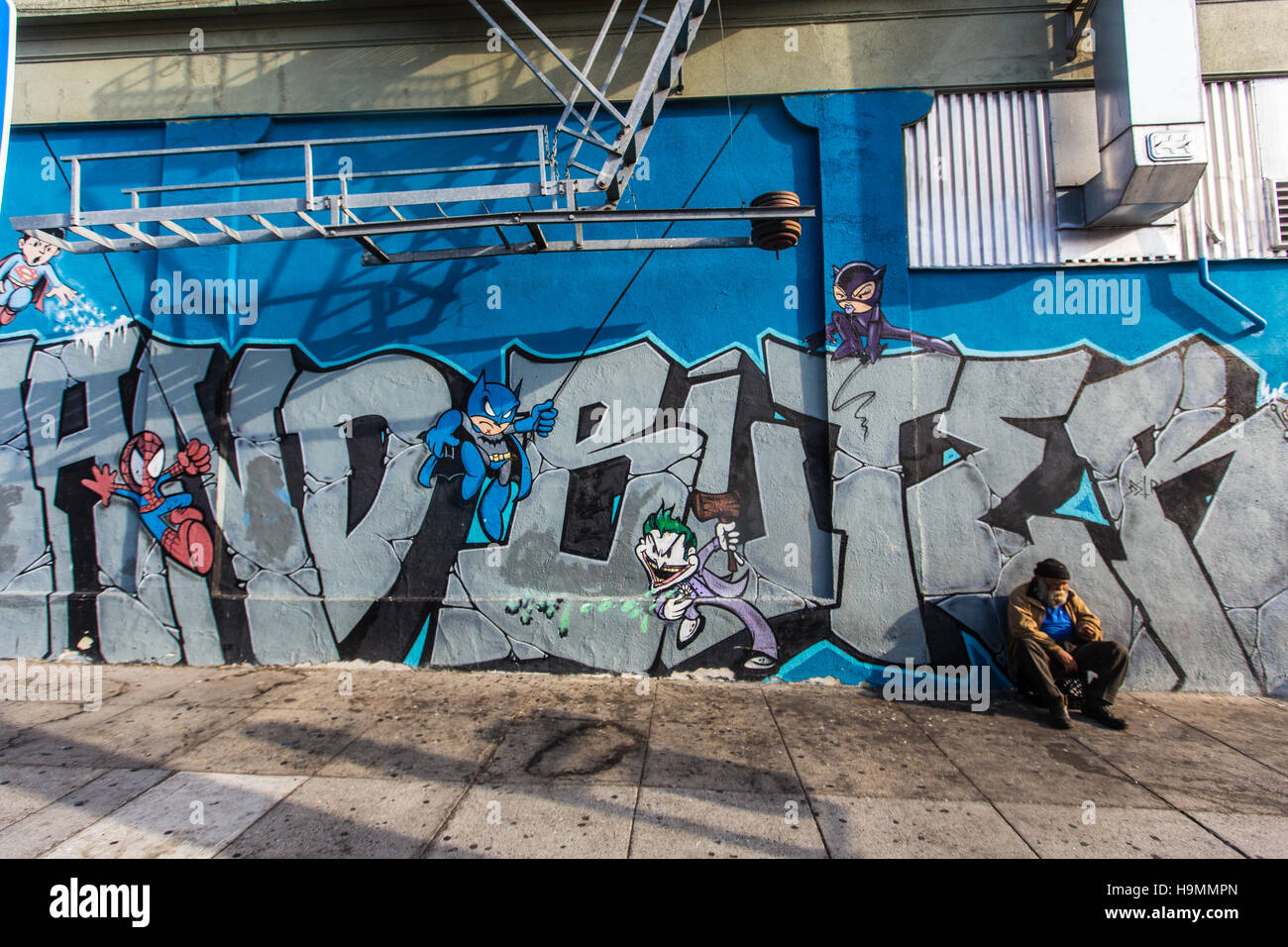 Homeless man and street art in the Mission, San Francisco, CA Stock Photo