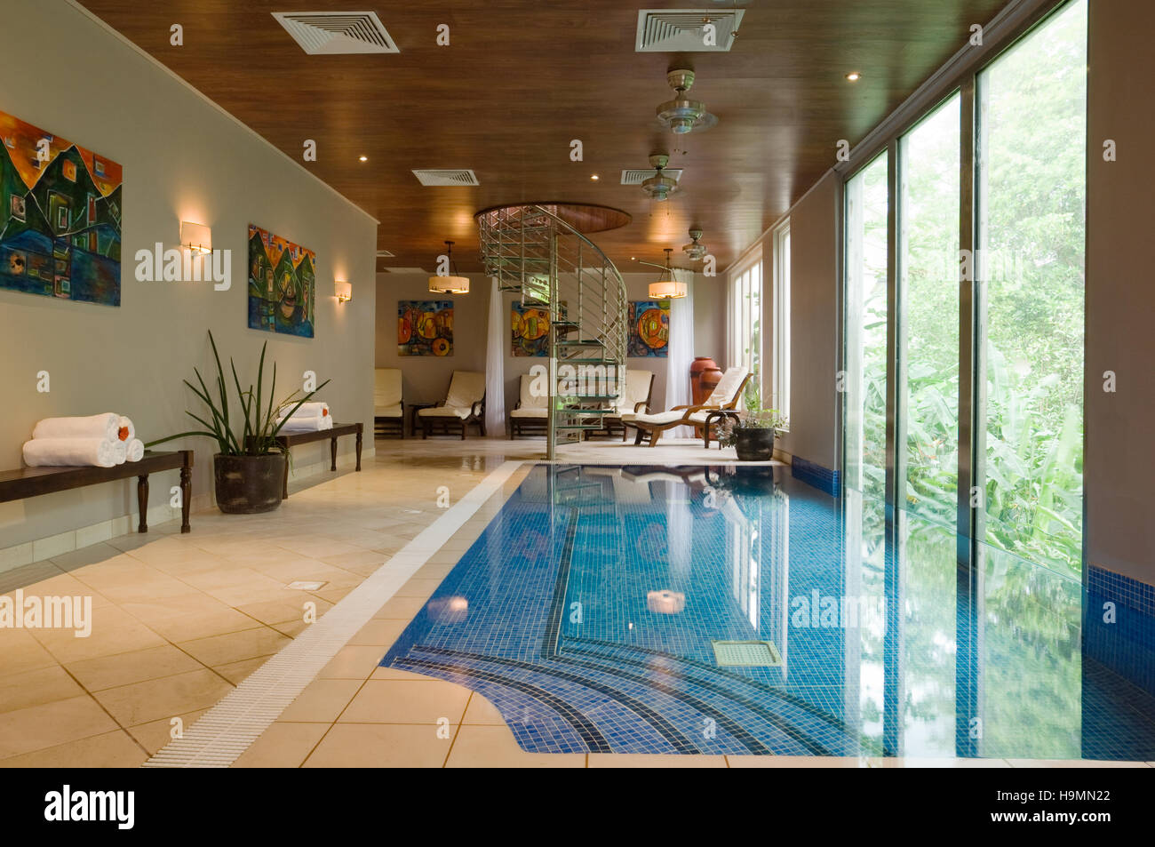 Swimming pool with full length windows and spiral staircase in Santa Lucia, spa resort, hotel and therapy centre, Caribbean Stock Photo