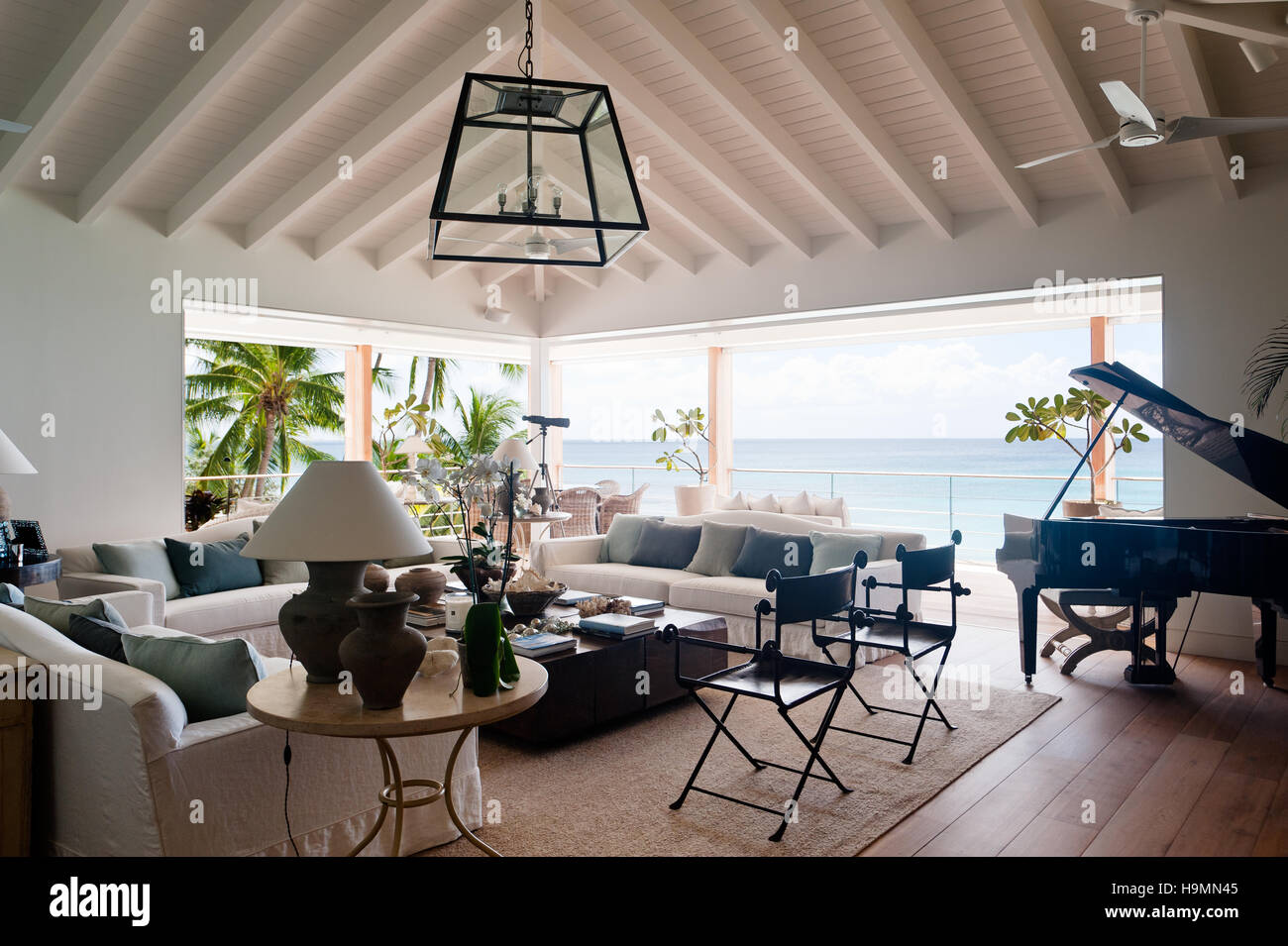 Seating area, grand piano in room with view to sea in Barbados, West Indies, Caribbean Stock Photo