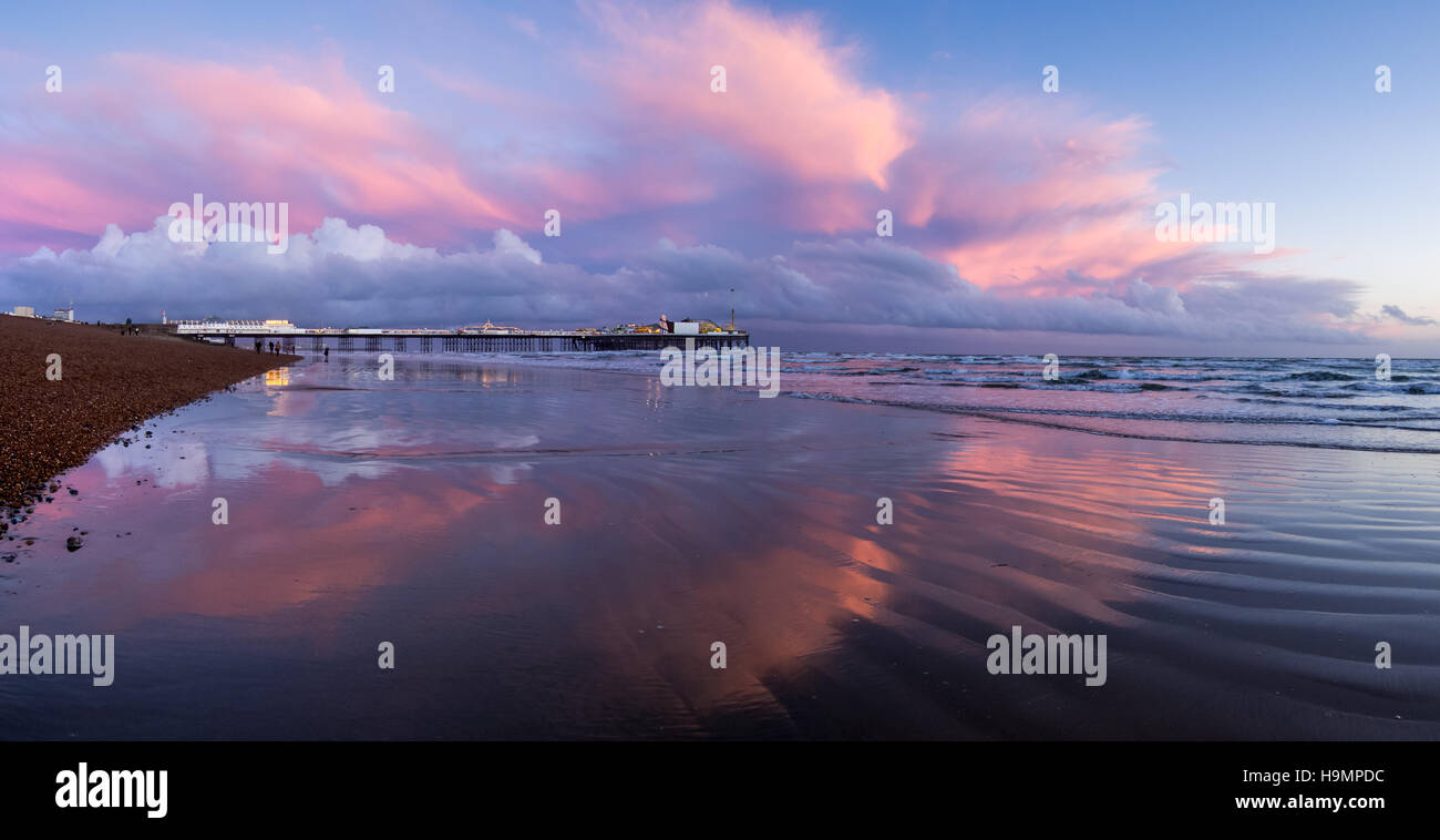 Panorama of Pink clouds around Brighton Palace Pier Stock Photo