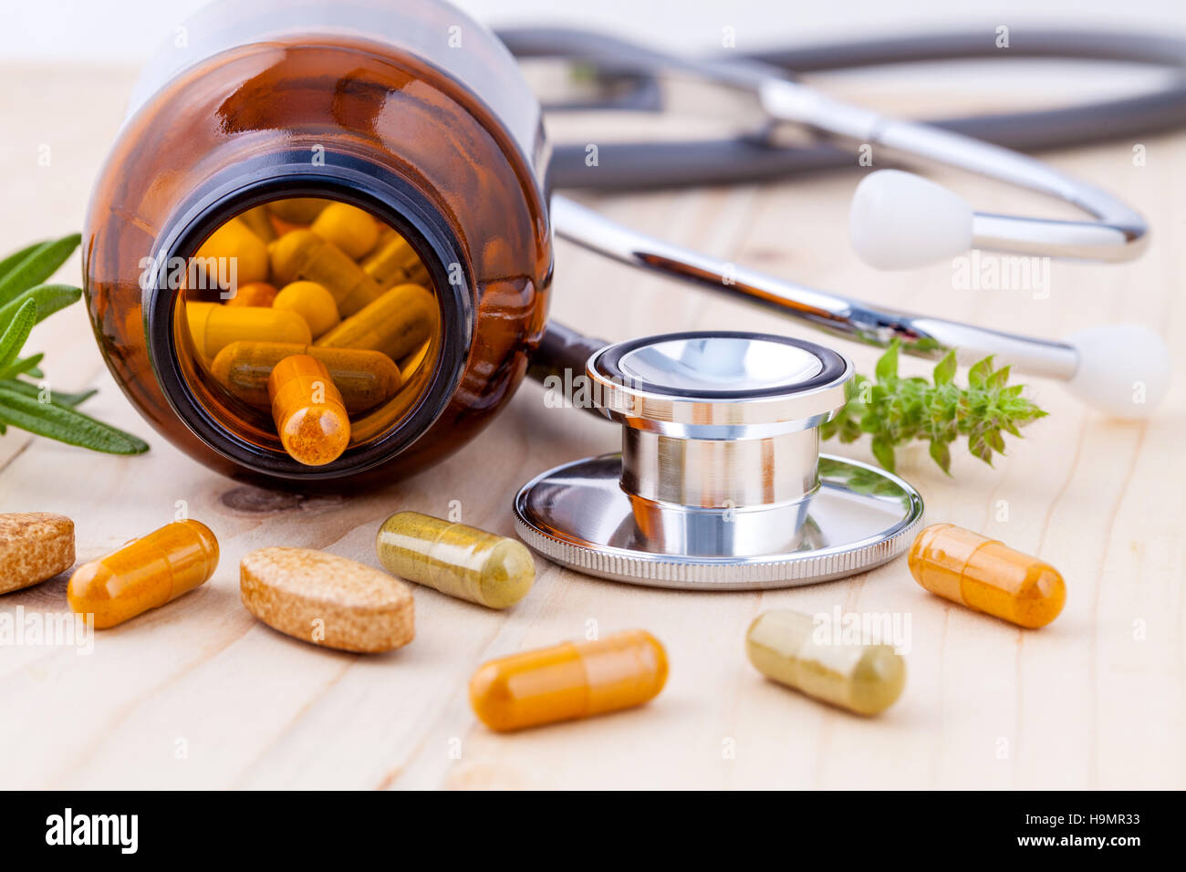 capsule of herbal medicine alternative healthy care with stethos Stock Photo