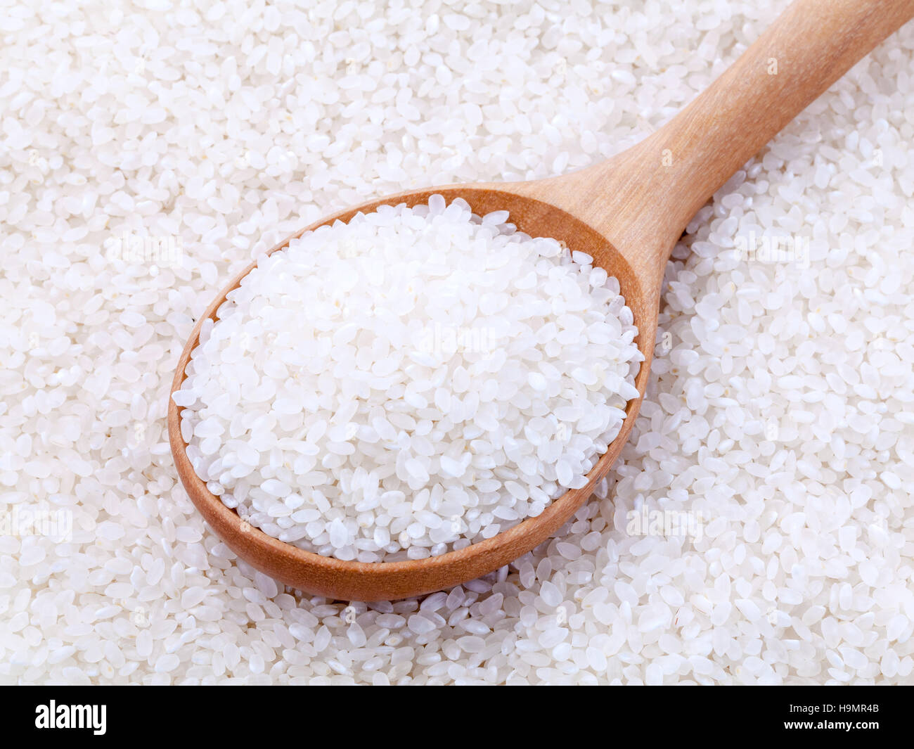 Japanese rice, the short rice used for sushi in wooden spoon wit Stock