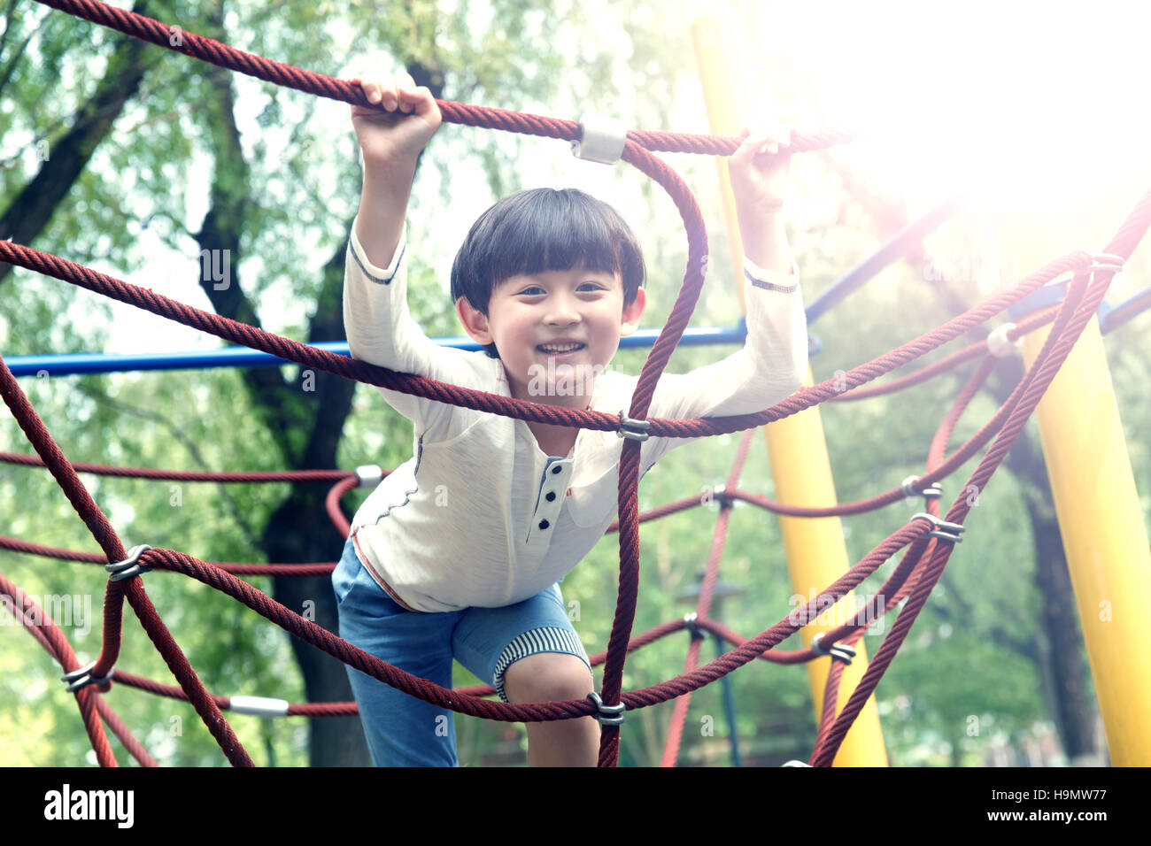 A little boy playing outdoors Stock Photo - Alamy