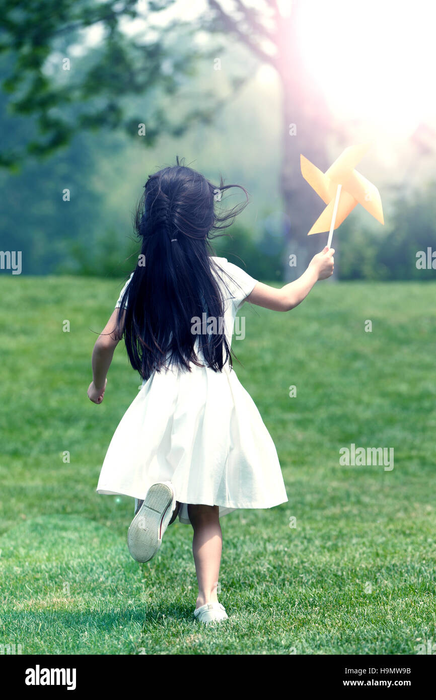 The little girl is playing on the grass Stock Photo - Alamy
