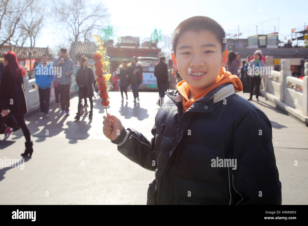 Happy boy holding Tomatoes on sticks Stock Photo - Alamy