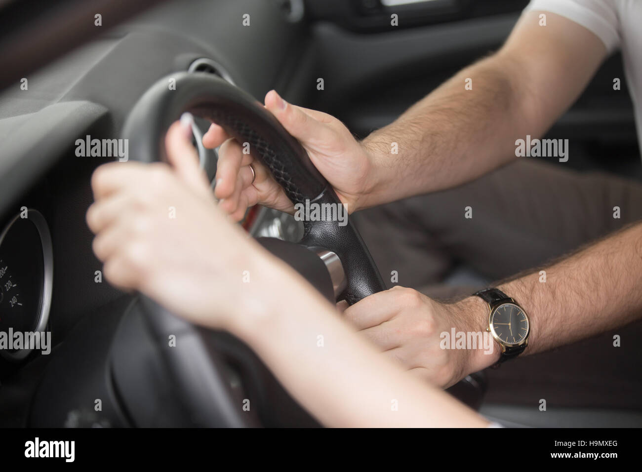 Man trying to take control of the steering wheel Stock Photo