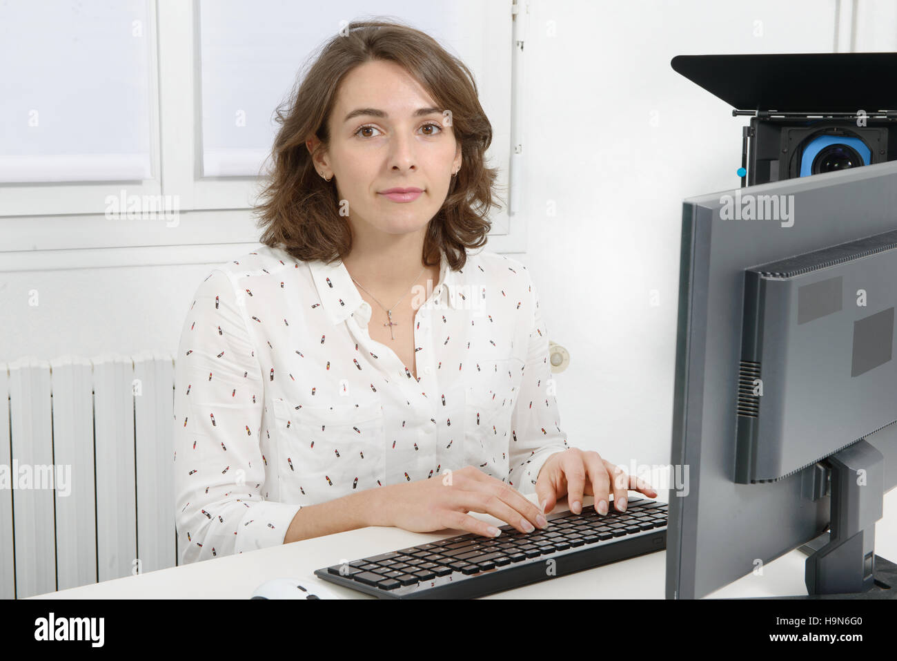 pretty young business woman working at pc in her office Stock Photo - Alamy