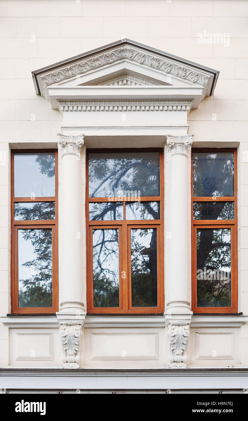 window on the facade of the old architectural building with arch Stock Photo