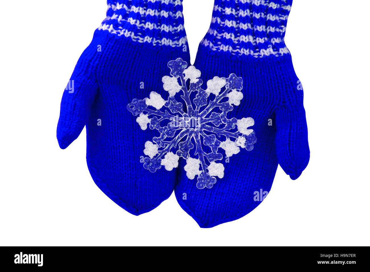 Christmas concept blue mittens with toy snowflake on a white background Stock Photo