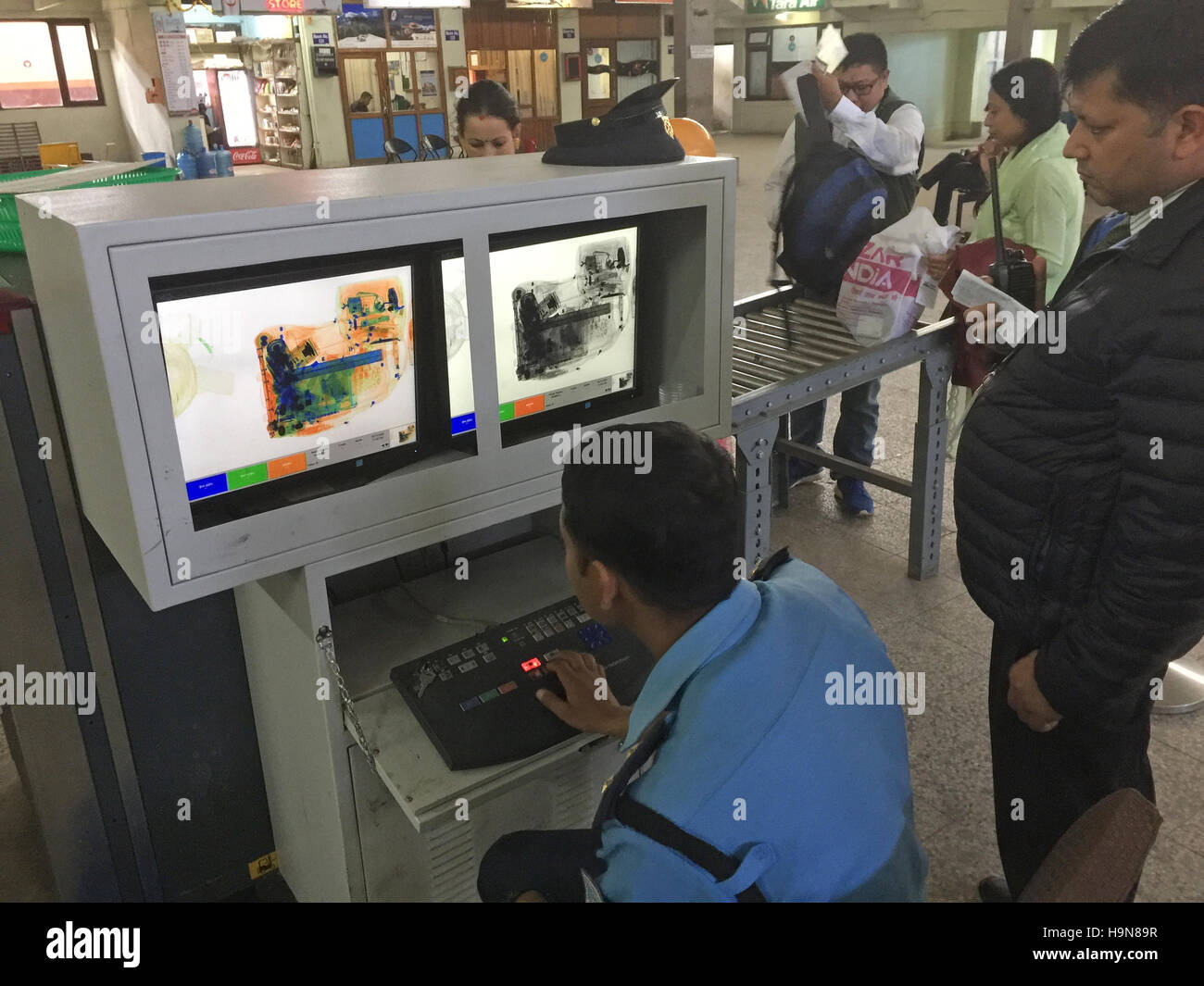 DELHI AIRPORT, India.  Scanner operator checking baggage. Photo Tony Gale Stock Photo