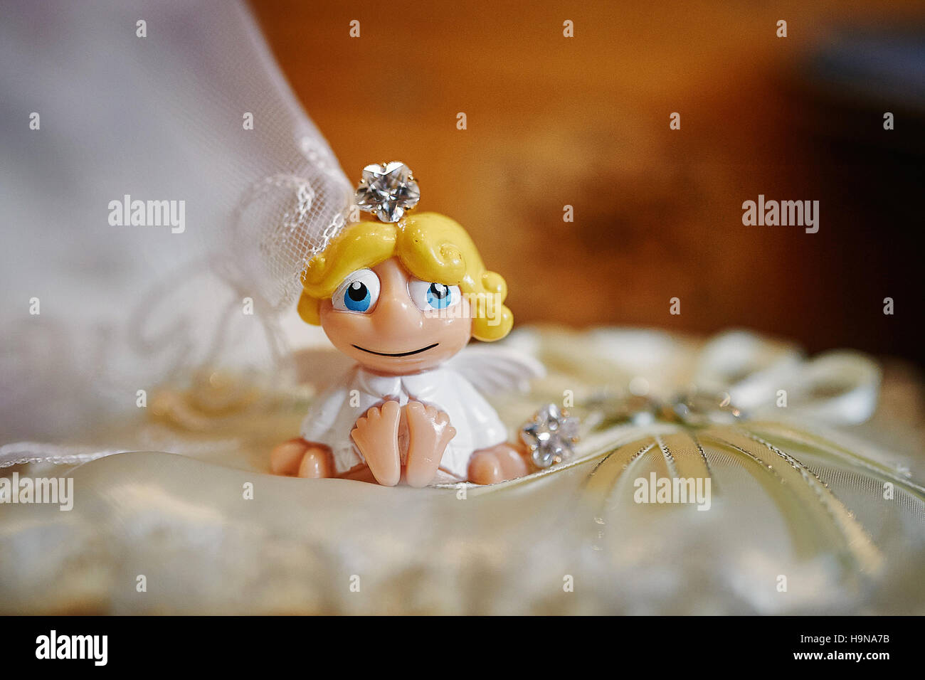 little toy Angel on a pillow for wedding rings Stock Photo