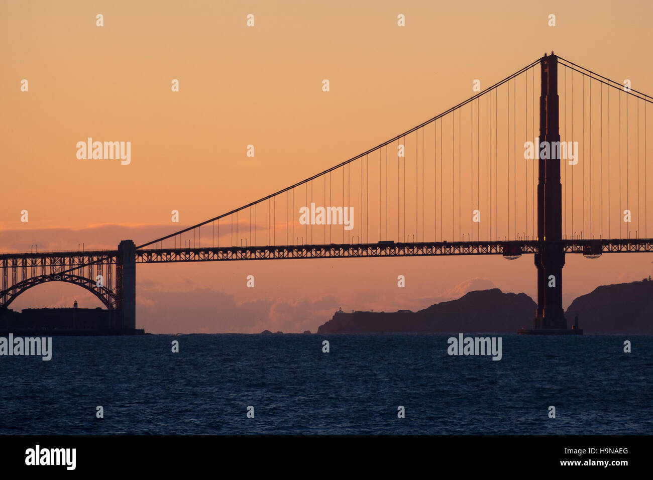 A silhouetted Golden Gate Bridge at sunset in San Francisco, California. Stock Photo