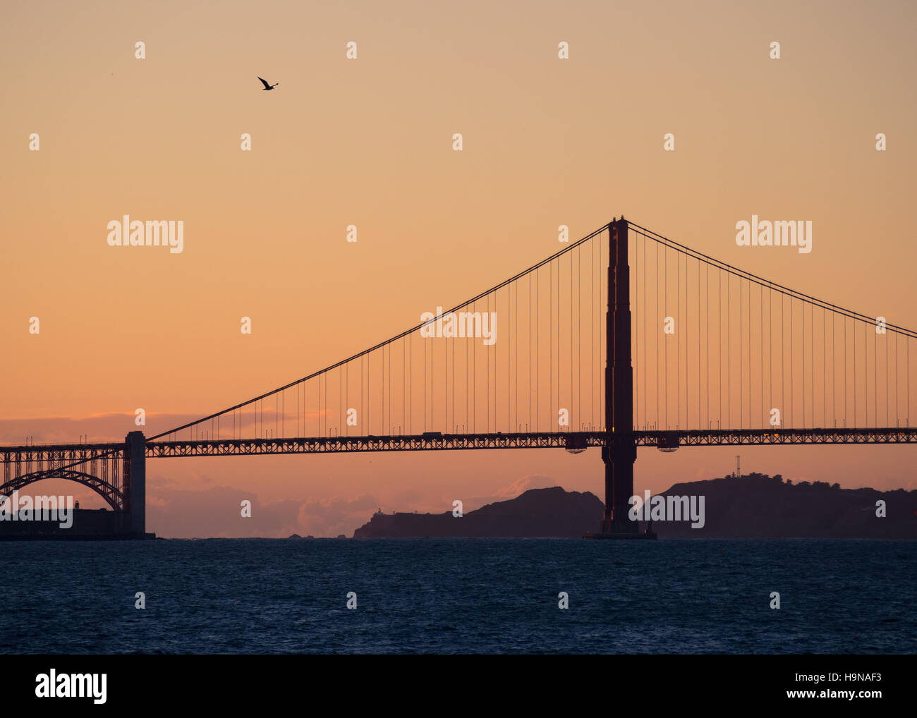 A silhouetted Golden Gate Bridge at sunset in San Francisco, California. Stock Photo