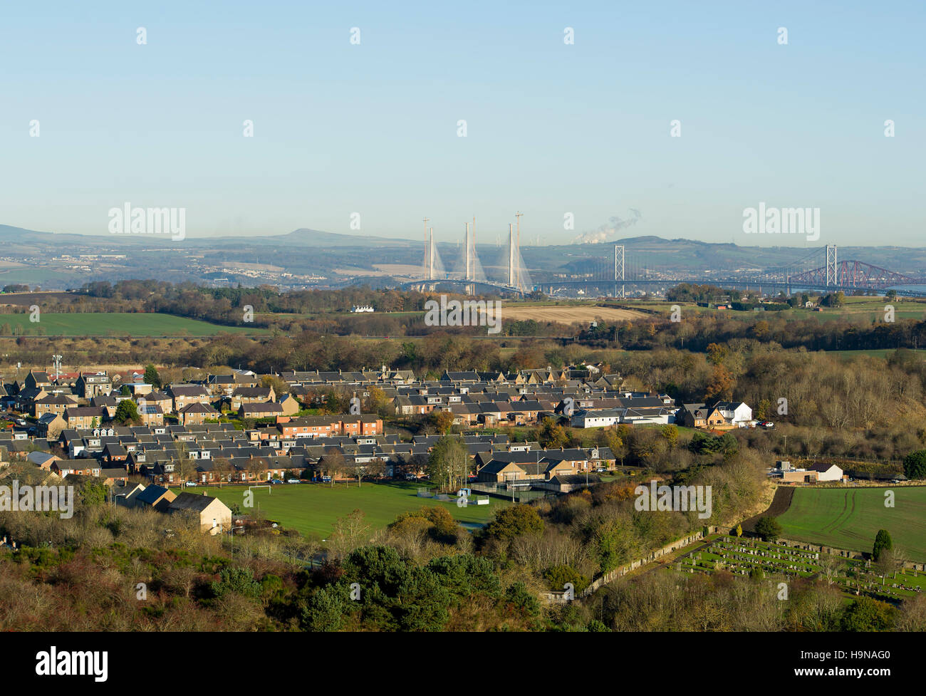 A view from West Lothian towards Fife showing the Queensferry Crossing under construction with the Forth Road Bridge, right. Stock Photo