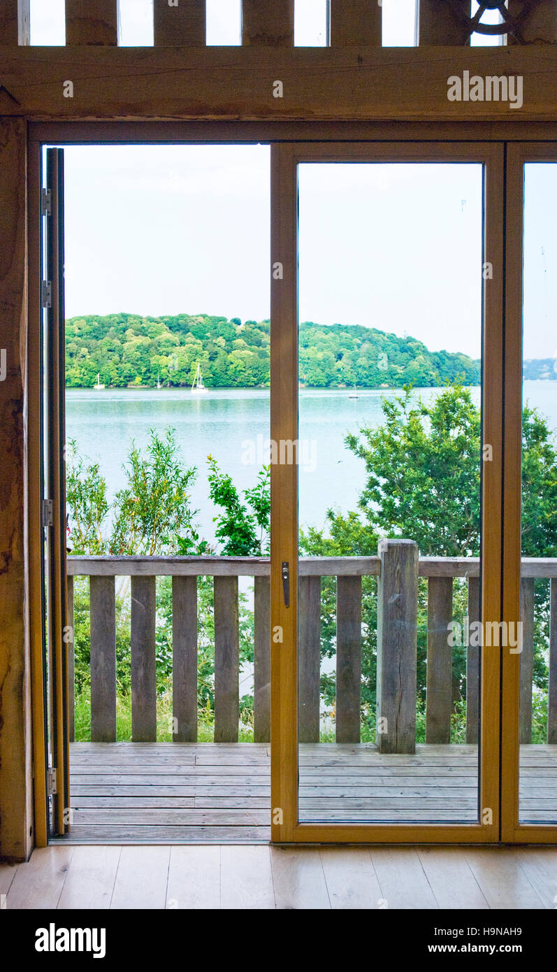 glazed doors overlooking water, natural wood, oak,balcony, deck,river view, seaview. Stock Photo