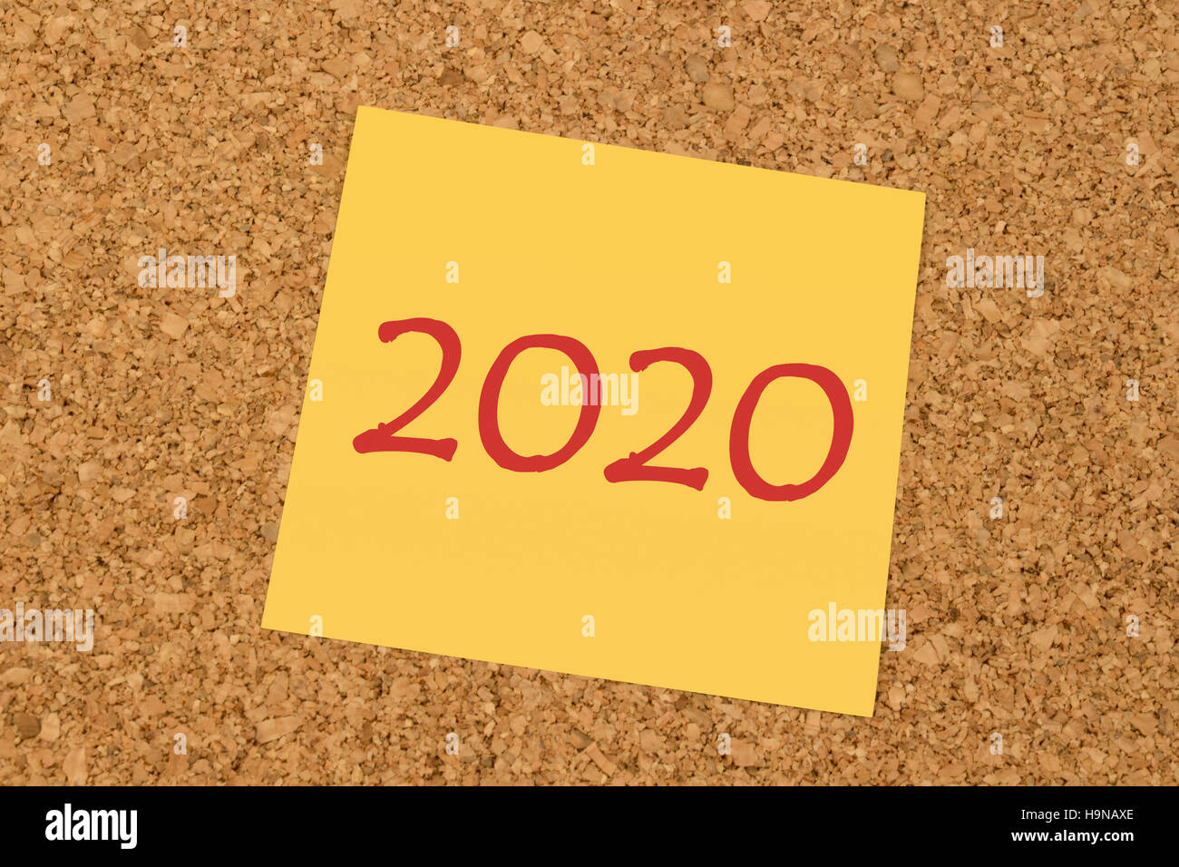 Yellow sticky note on an office cork board - New Year 2020 Stock Photo