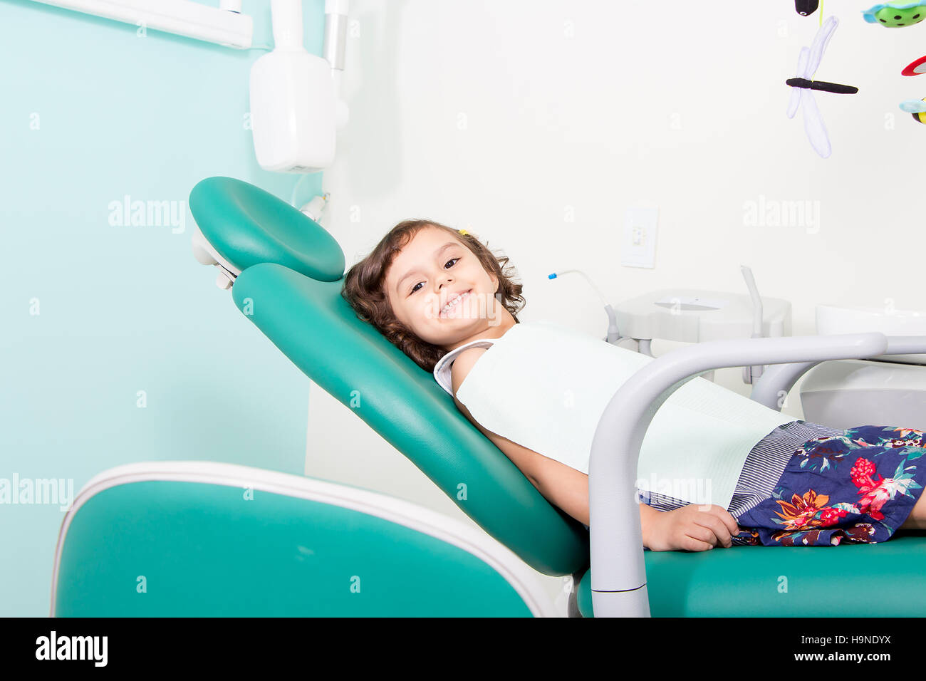 Little cute girl smiling while sitting in chair at dental clinic Stock ...