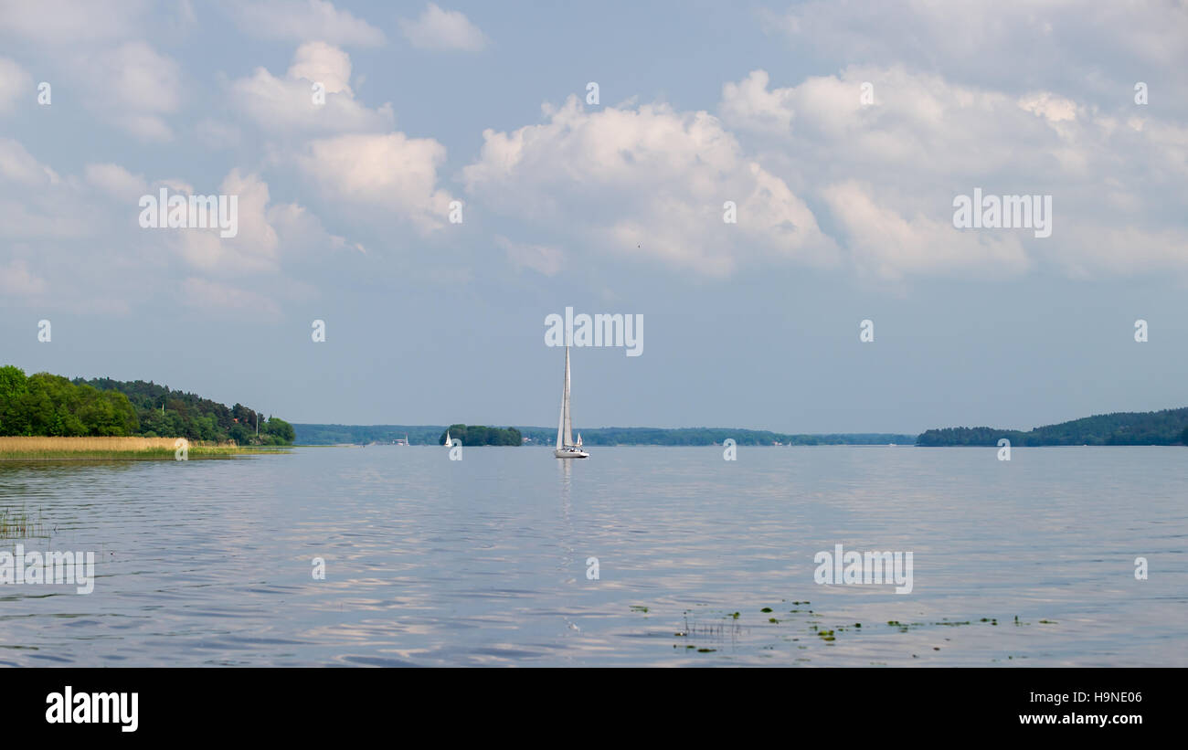 Green Virgin is the name of the small island between the sails in the Lake Malaren's northern part Ekoln, Uppland, Sweden Stock Photo