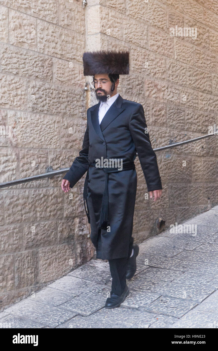 jewish man in suit and furry square hat walking in jerusalem Stock Photo