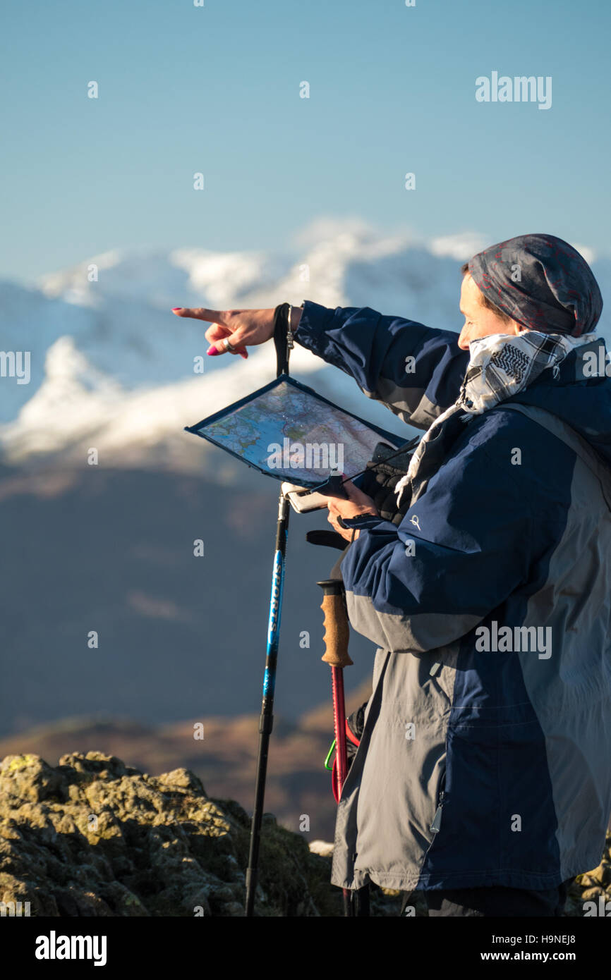 Woman looking at map and pointing which way to go Stock Photo