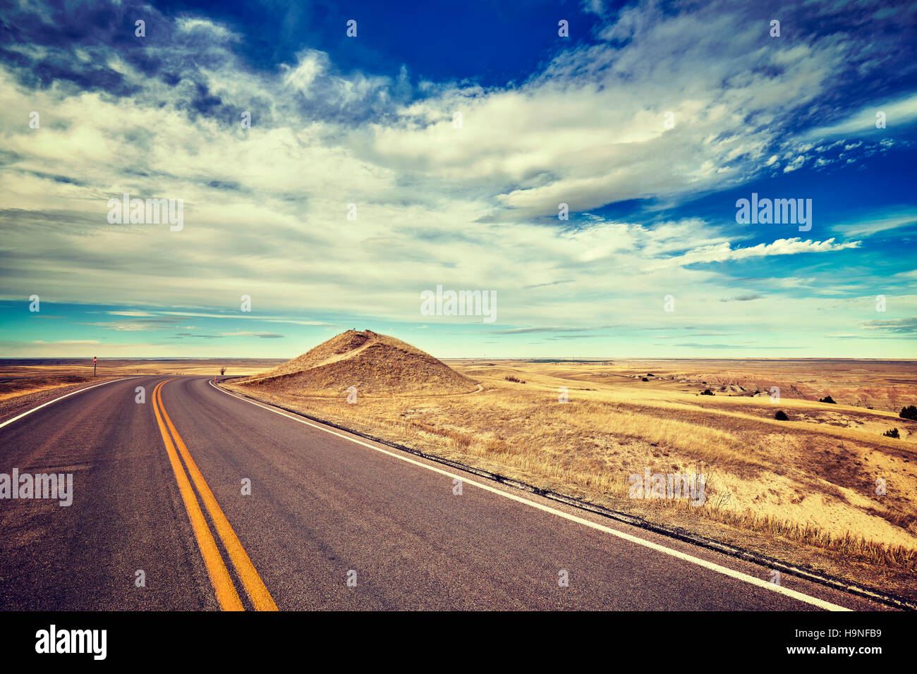 Vintage stylized empty road, travel concept, USA. Stock Photo