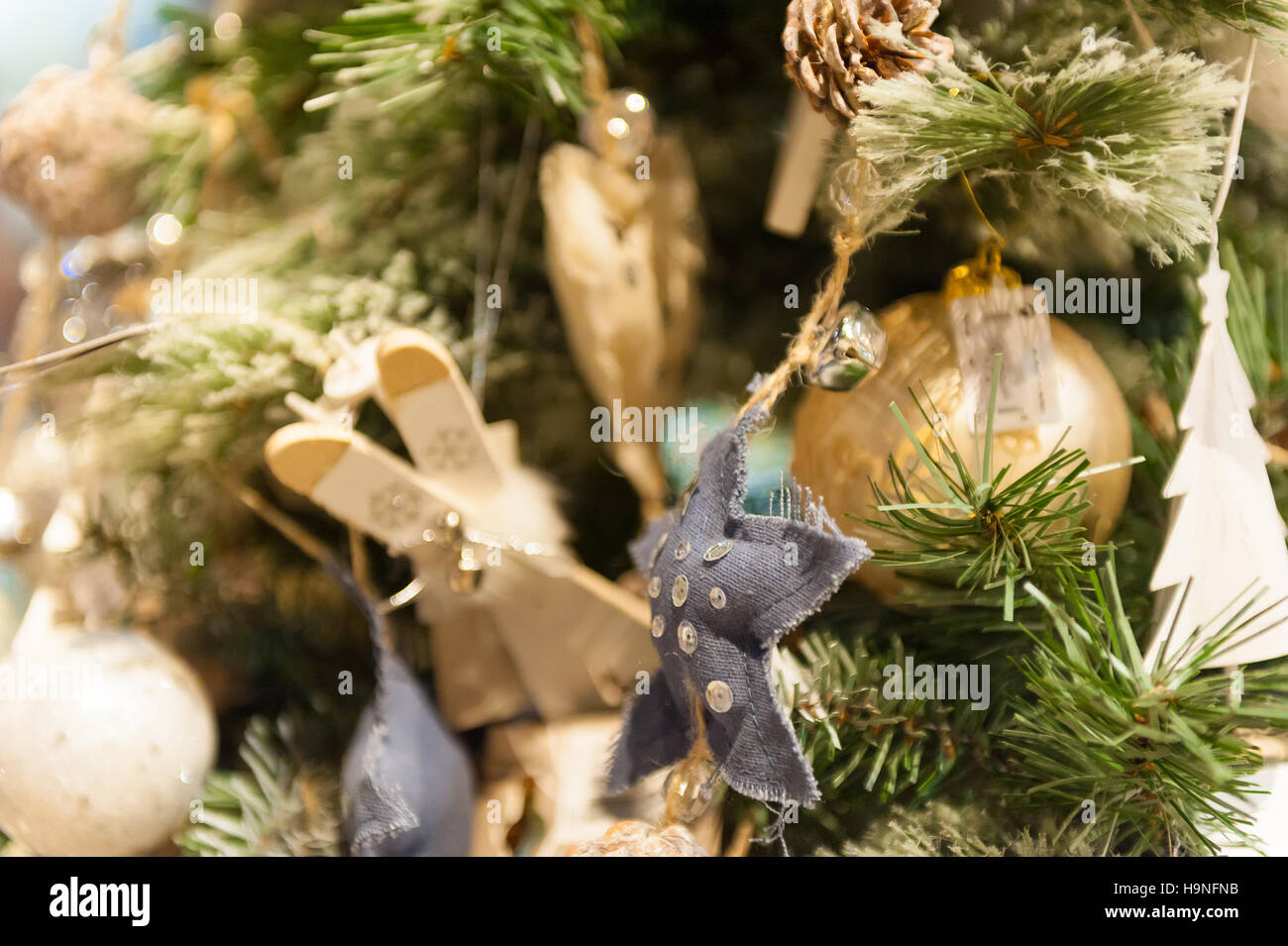 Homemade Christmas toys wooden skis stars and balls hanging on the Christmas tree. Stock Photo