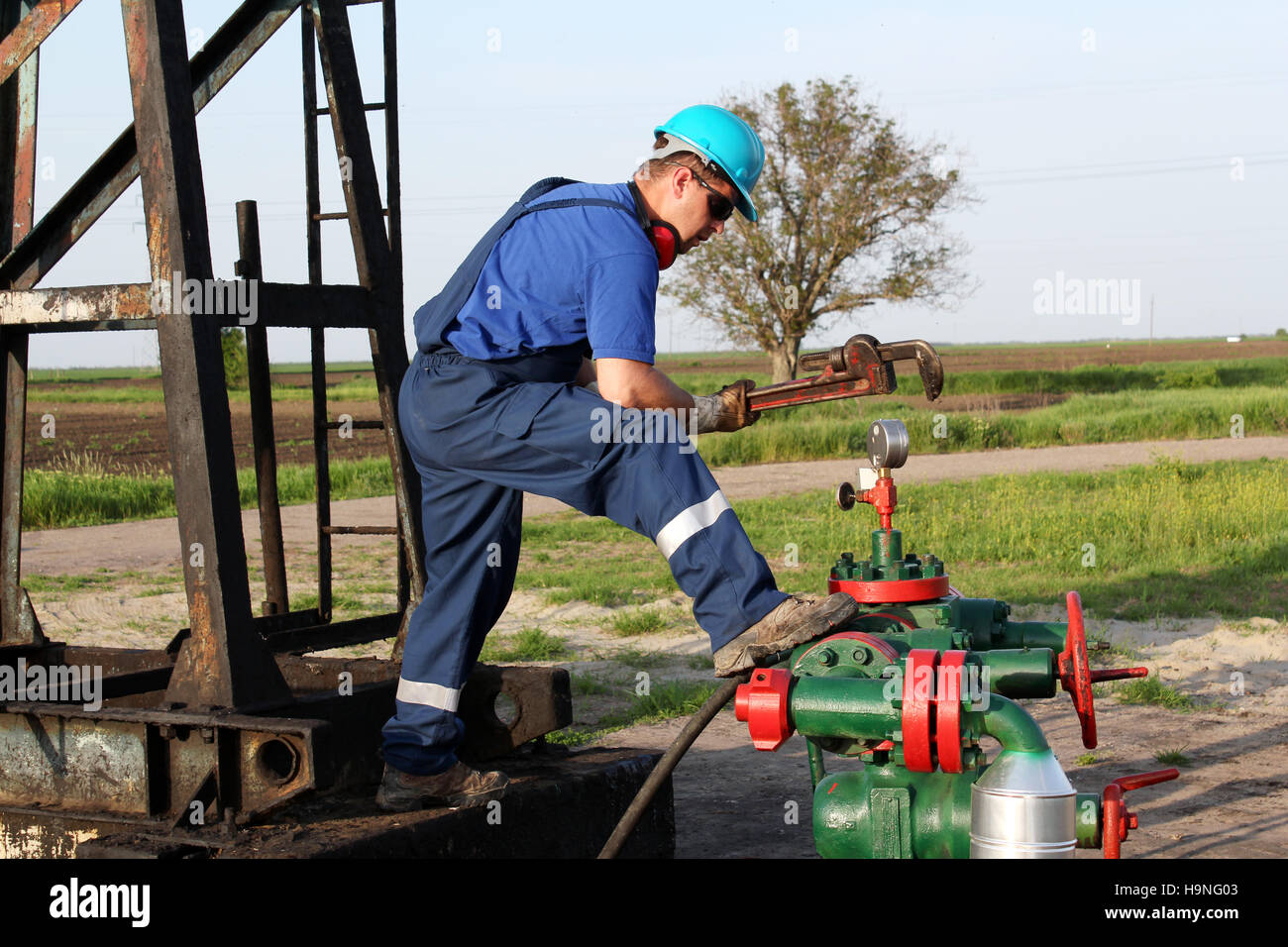oil worker with wrench check pipeline Stock Photo