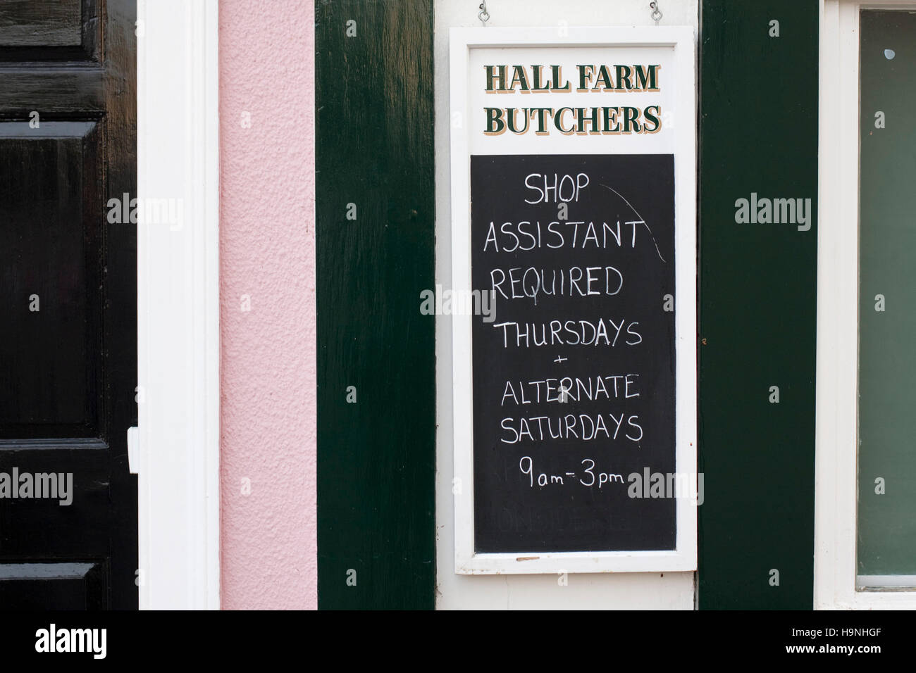 Help needed sign outside Suffolk butchers Stock Photo