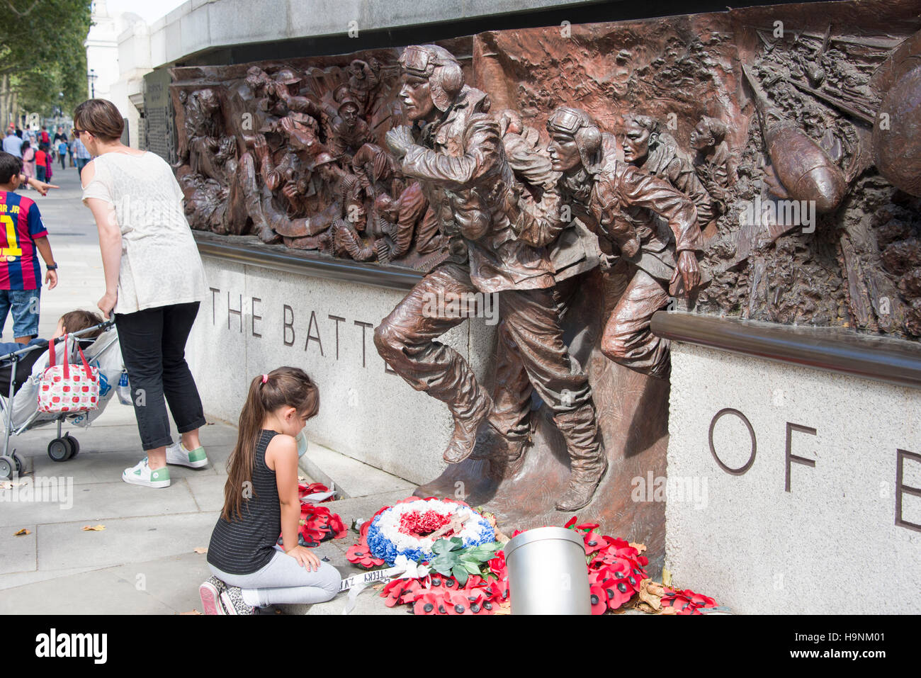 The Battle of Britain Monument with girl laying flowers Stock Photo - Alamy
