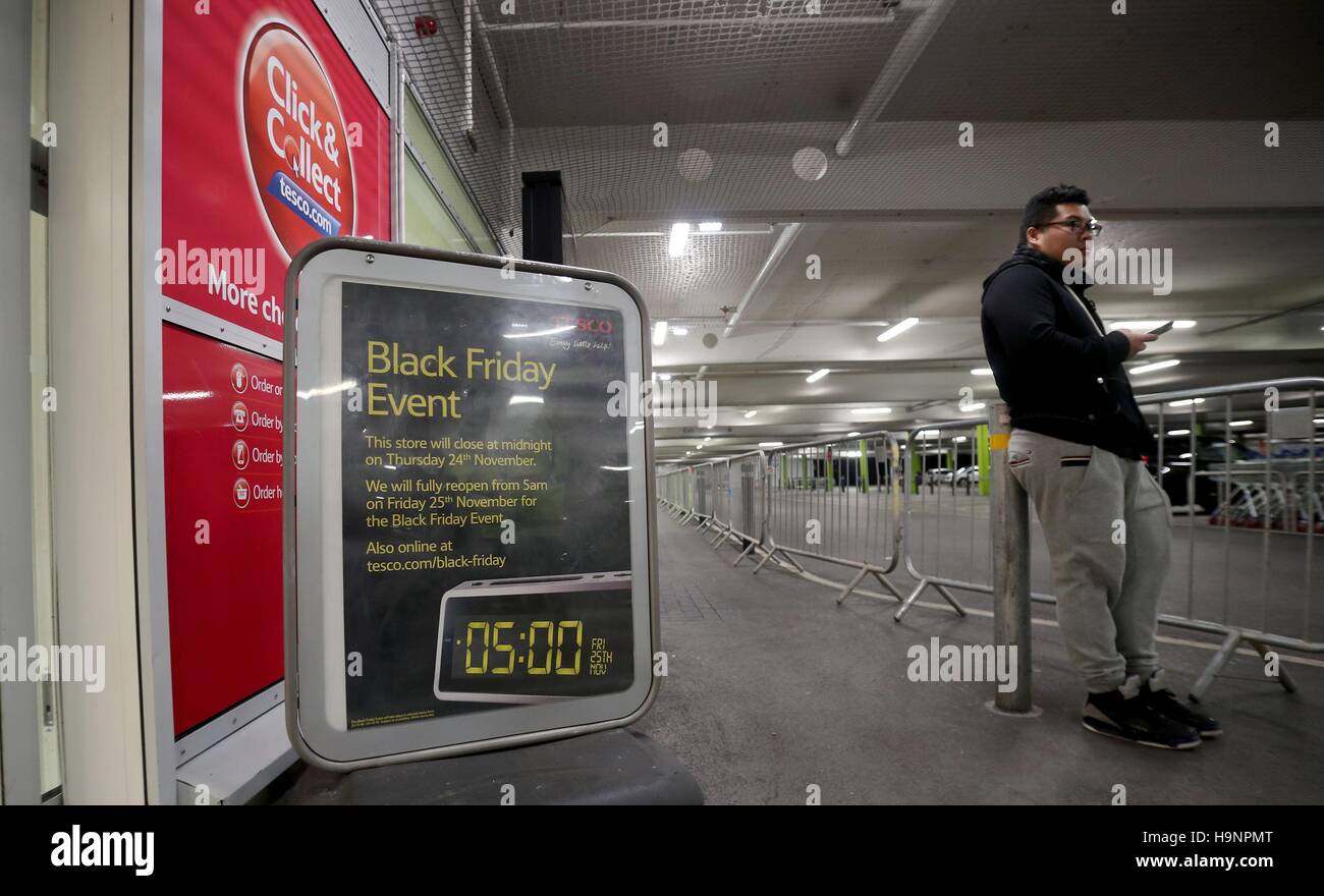 A single person at the front of the queue at the Tesco Extra store in Manchester, waits for the start of their Black Friday Sale. Stock Photo