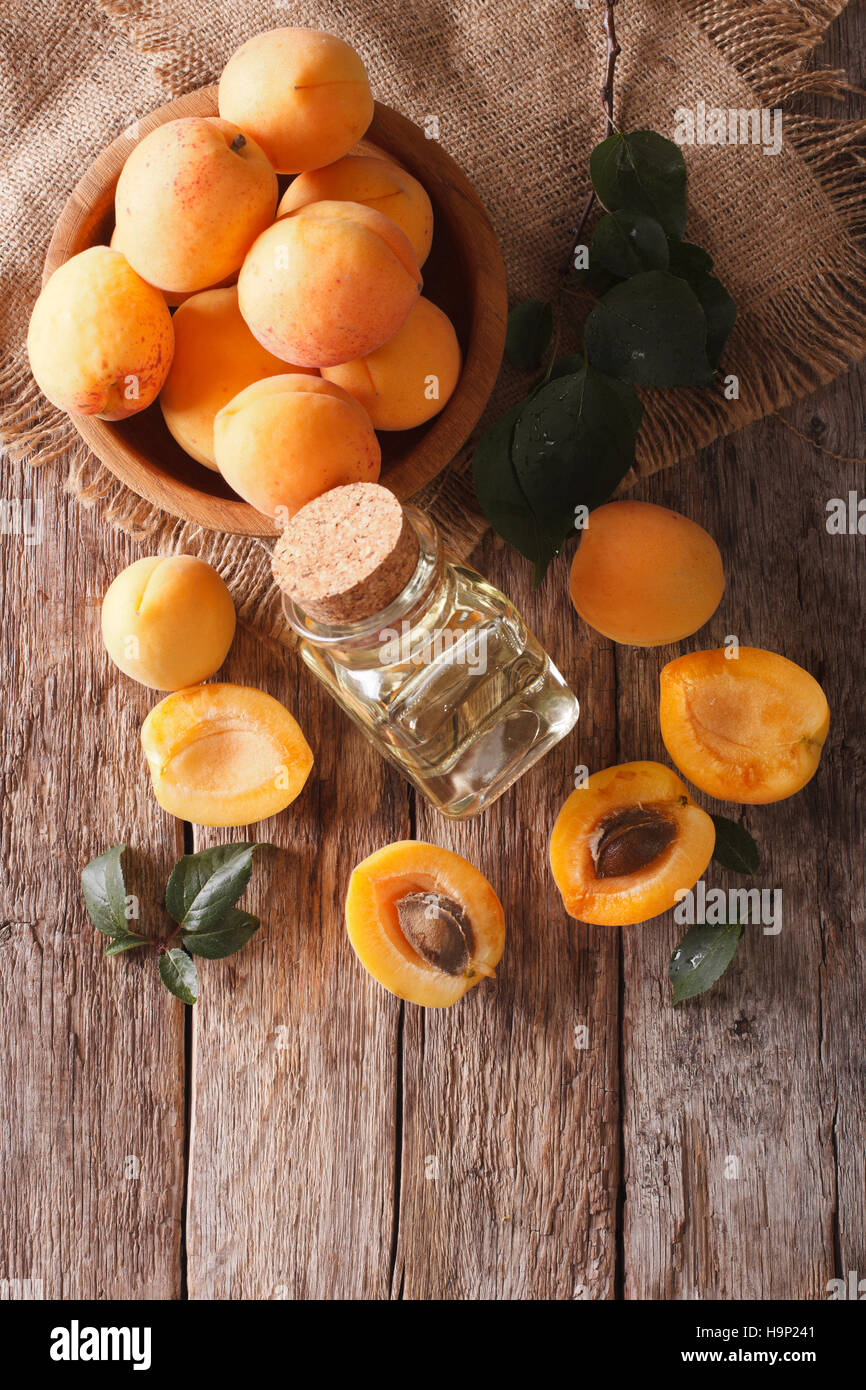 apricot kernel oil in a glass jar closeup on the table and ingredients