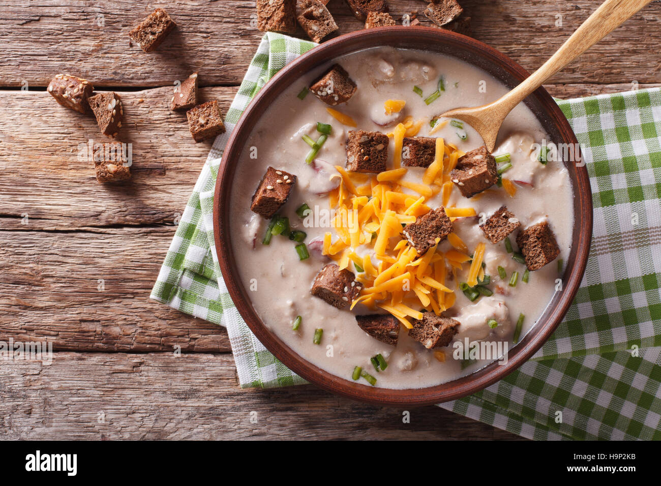 Bavarian beer soup with cheese and bacon close up in a bowl on the table. horizontal view from above Stock Photo