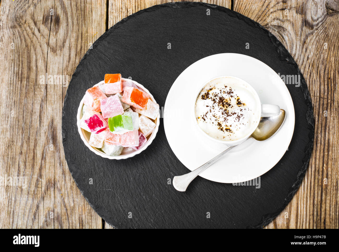 Eastern dessert Turkish delight and coffee with cream. Studio Photo