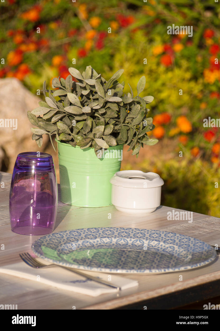 Detail of a decorated table in a sunny garden Stock Photo