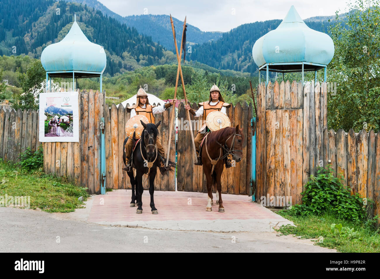 Two riders in front of the entrance of the Kazakh ethnographical village Aul Gunny, Talgar city, Almaty, Kazakhstan Stock Photo