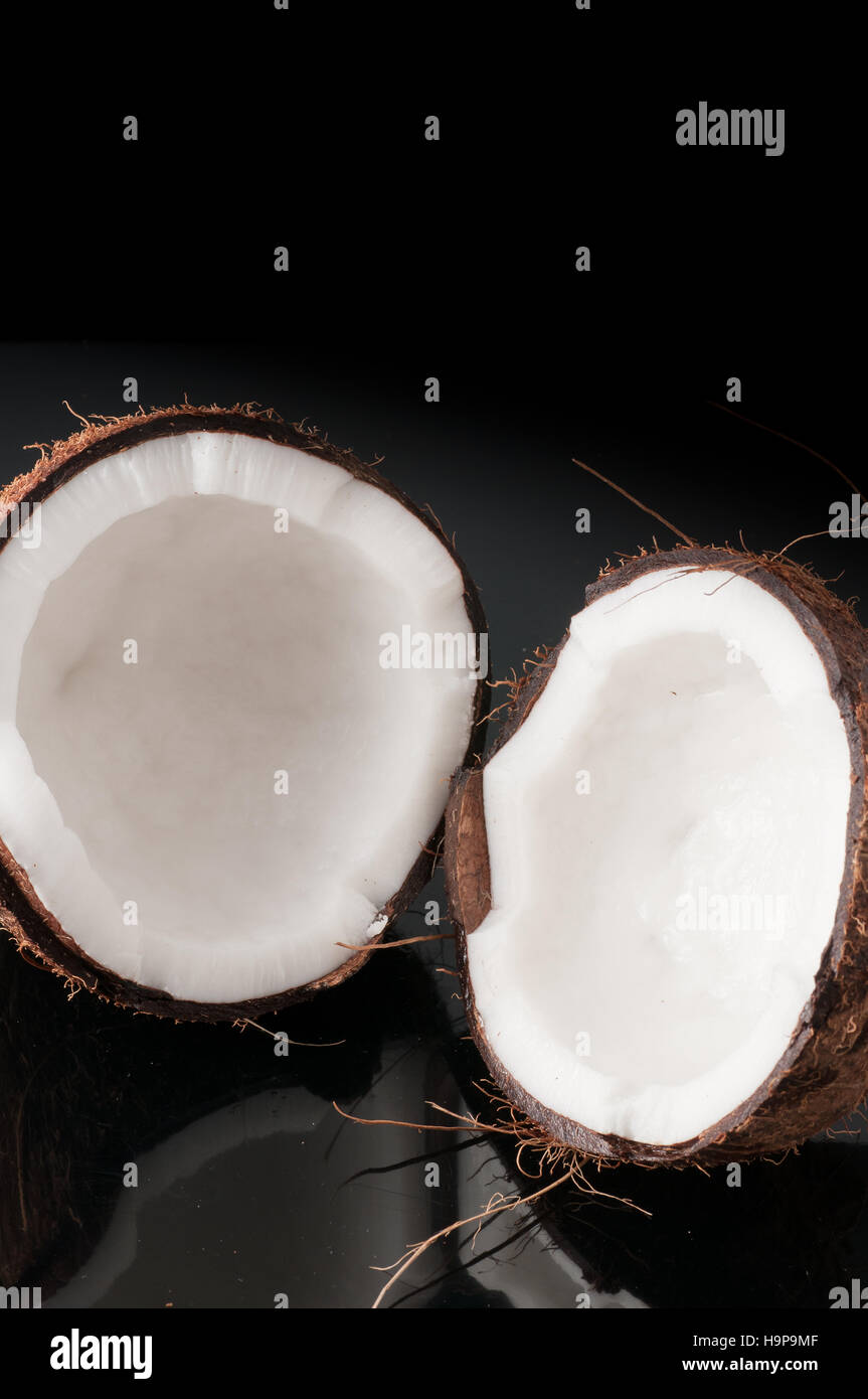 Coconut broken in half Stock Photo Alamy