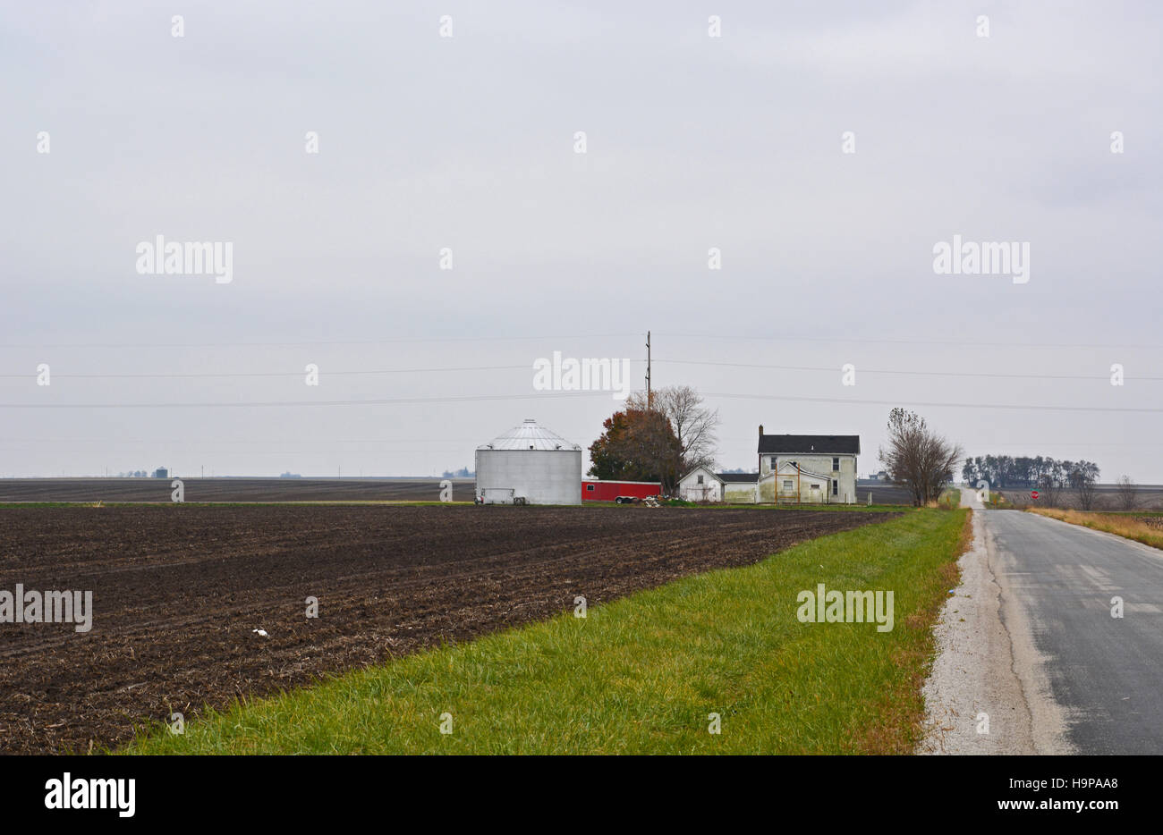 A Central Illinois farmhouse under cold gray November skies in the Midwestern United States. Stock Photo
