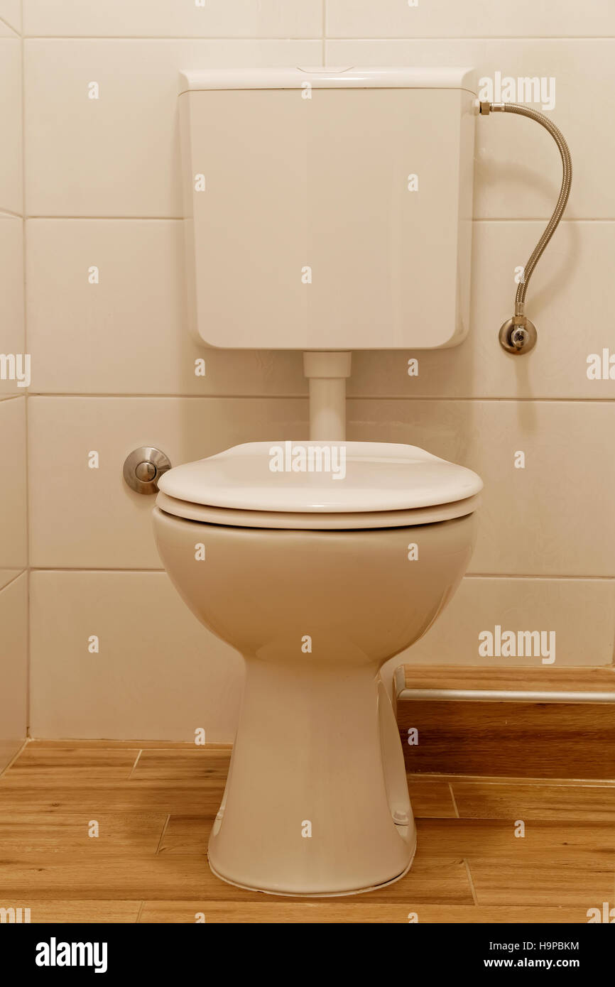 white toilet bowl and lavatory cistern Stock Photo