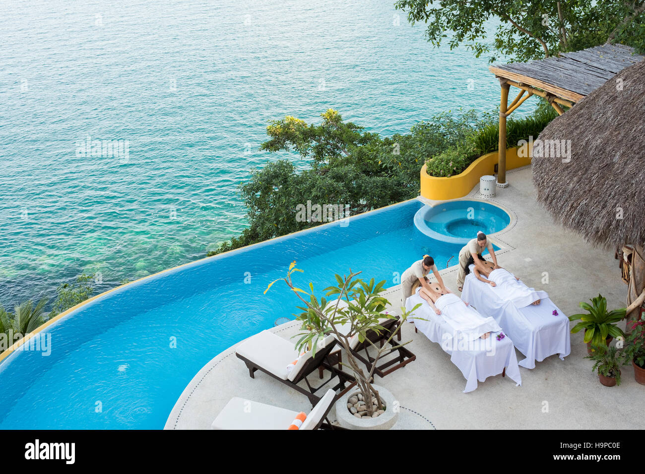 View from above at two women getting a massage on the terrace of an ocean front luxury wellness retreat in Mismaloya, Puerto Vallarta South Shore, Jal Stock Photo
