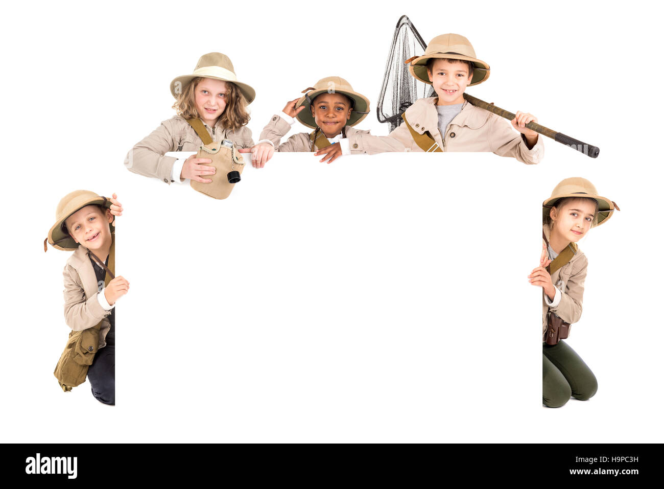 Children's group with safari clothes and gear over a white board Stock ...