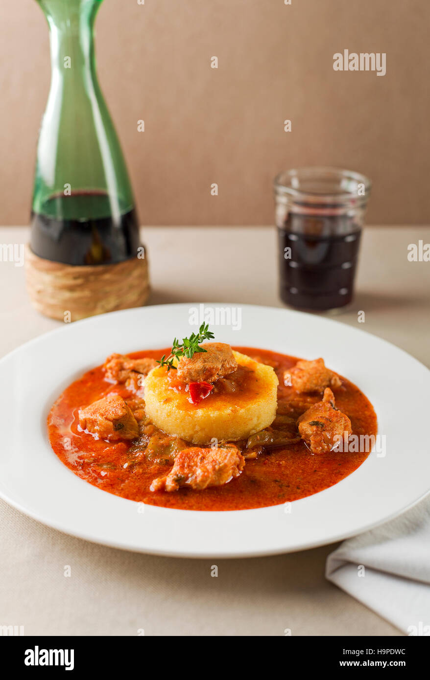 Portion of traditional meat stew - goulash on white plate Stock Photo