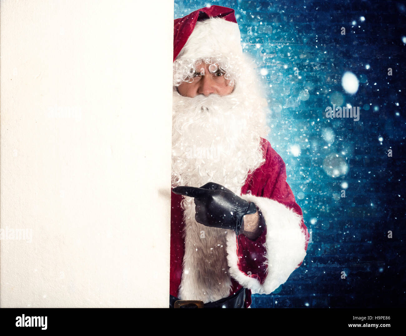 Portrait of Santa Claus pointing on blank billboard Stock Photo - Alamy