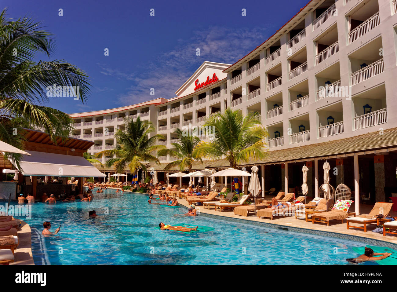 Main building and pool of the Sandals Resort Hotel, St. Lawrence Gap, South Coast, Barbados, Caribbean. Stock Photo