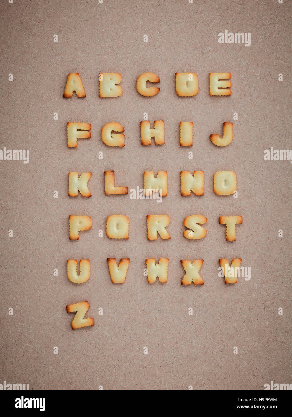 Cookies ABC in the form of alphabet A-Z on brown cardboard backg Stock Photo