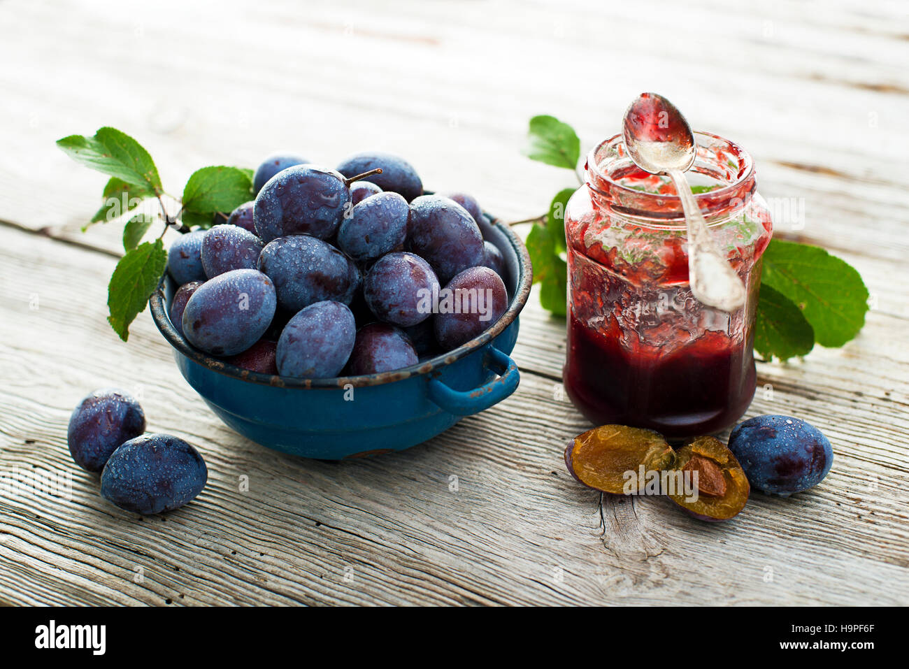 Plums and  marmelade on wooden background close up Stock Photo