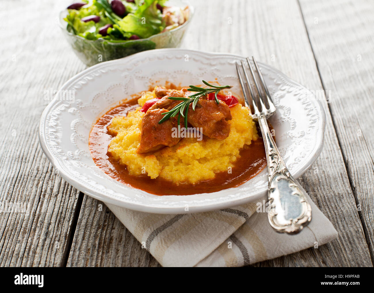 Goulash with polenta on wooden background close up Stock Photo