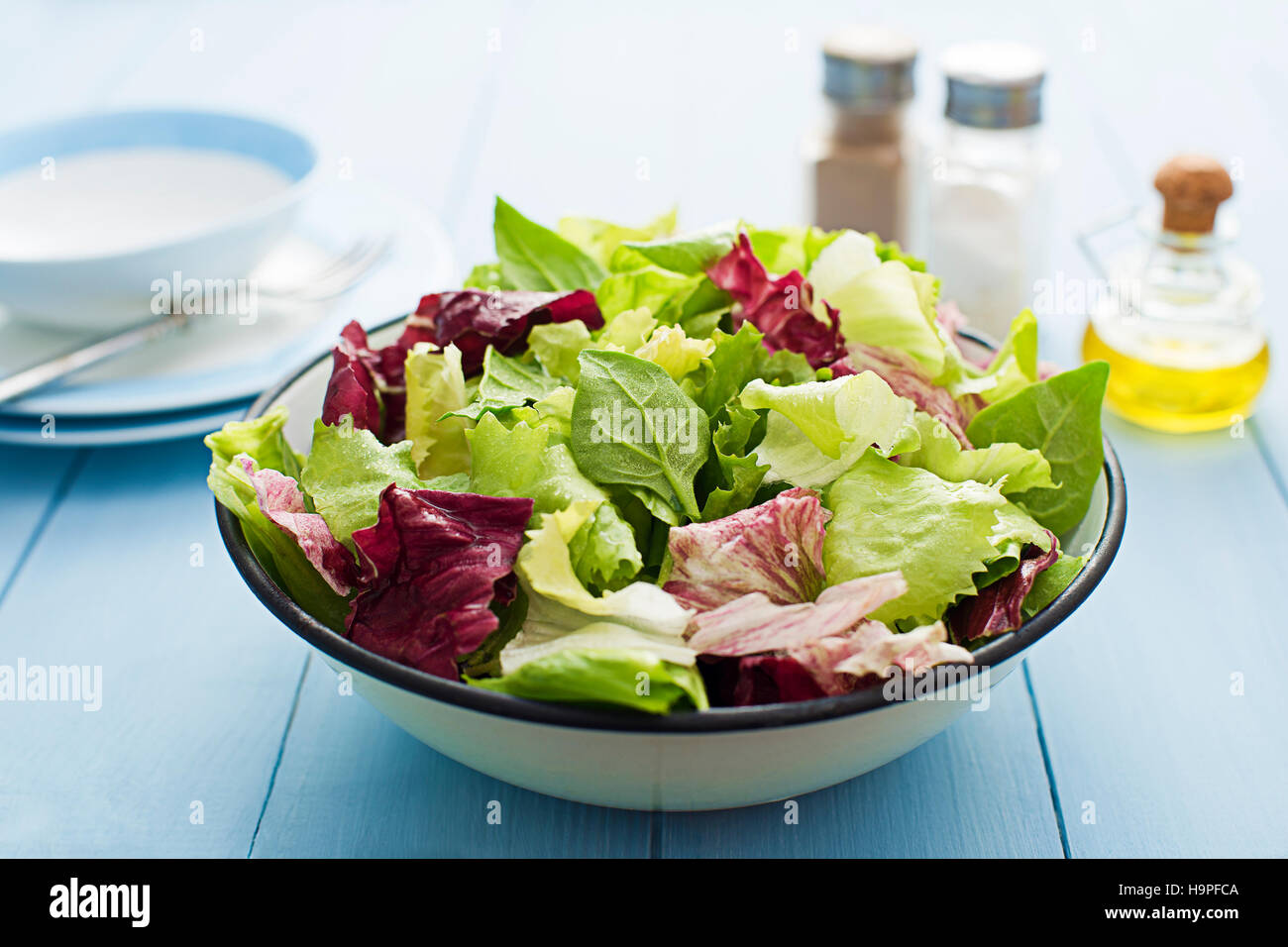 Fresh mixed green salad in a bowl close up Stock Photo