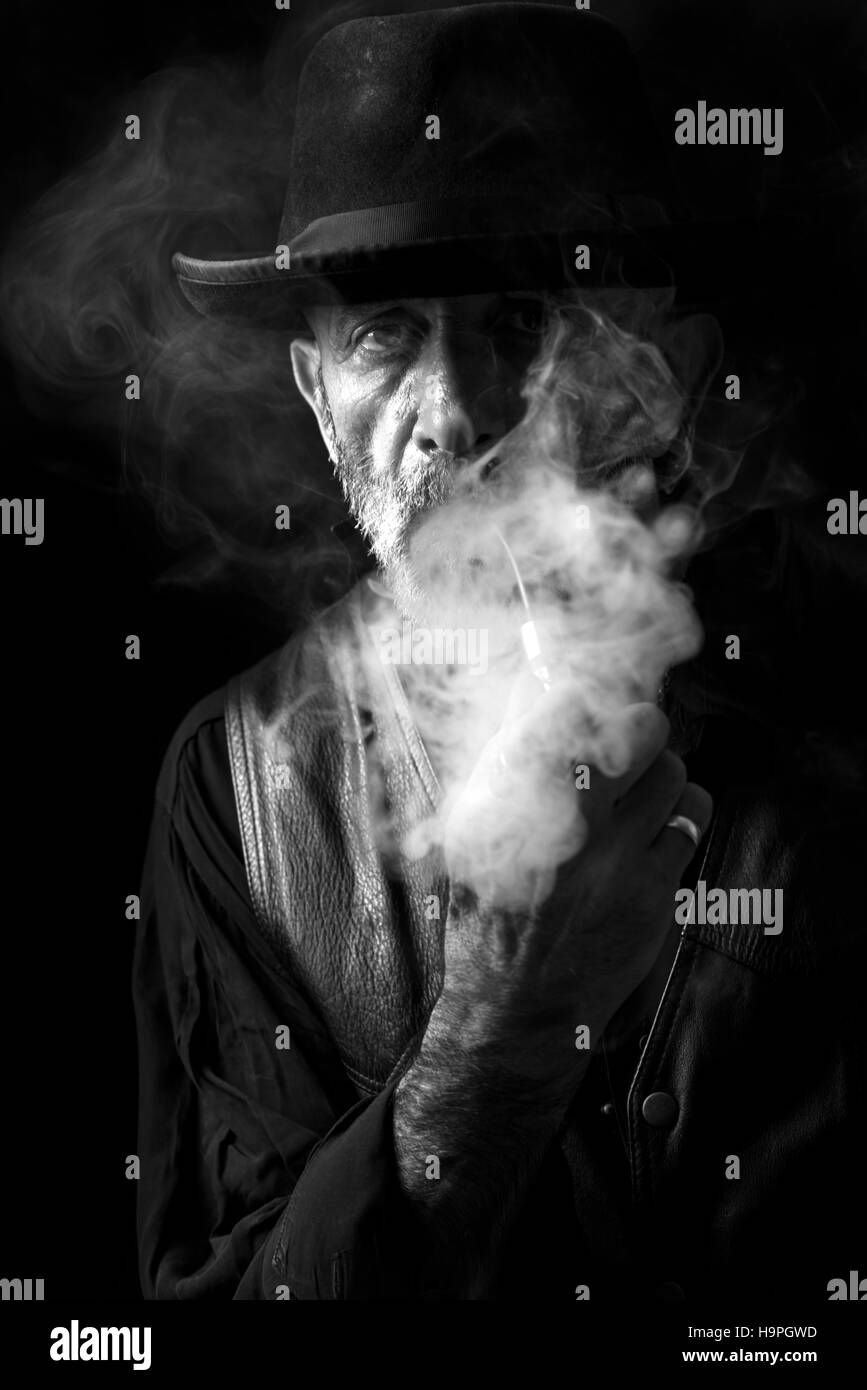 Portrait of man who smoking his pipe,low key technique Stock Photo Alamy