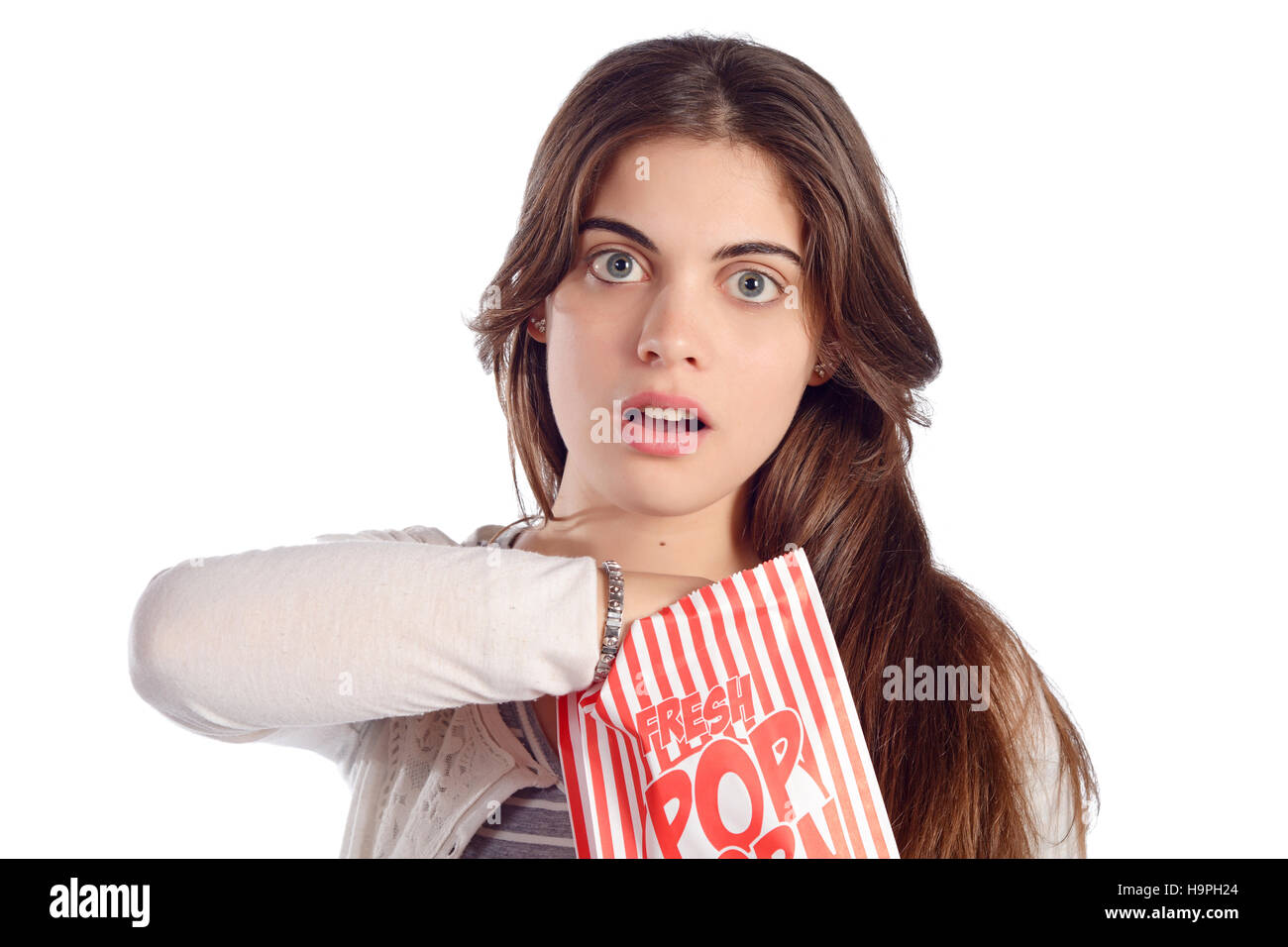 Young beautiful woman eating popcorn. Isolated white background Stock