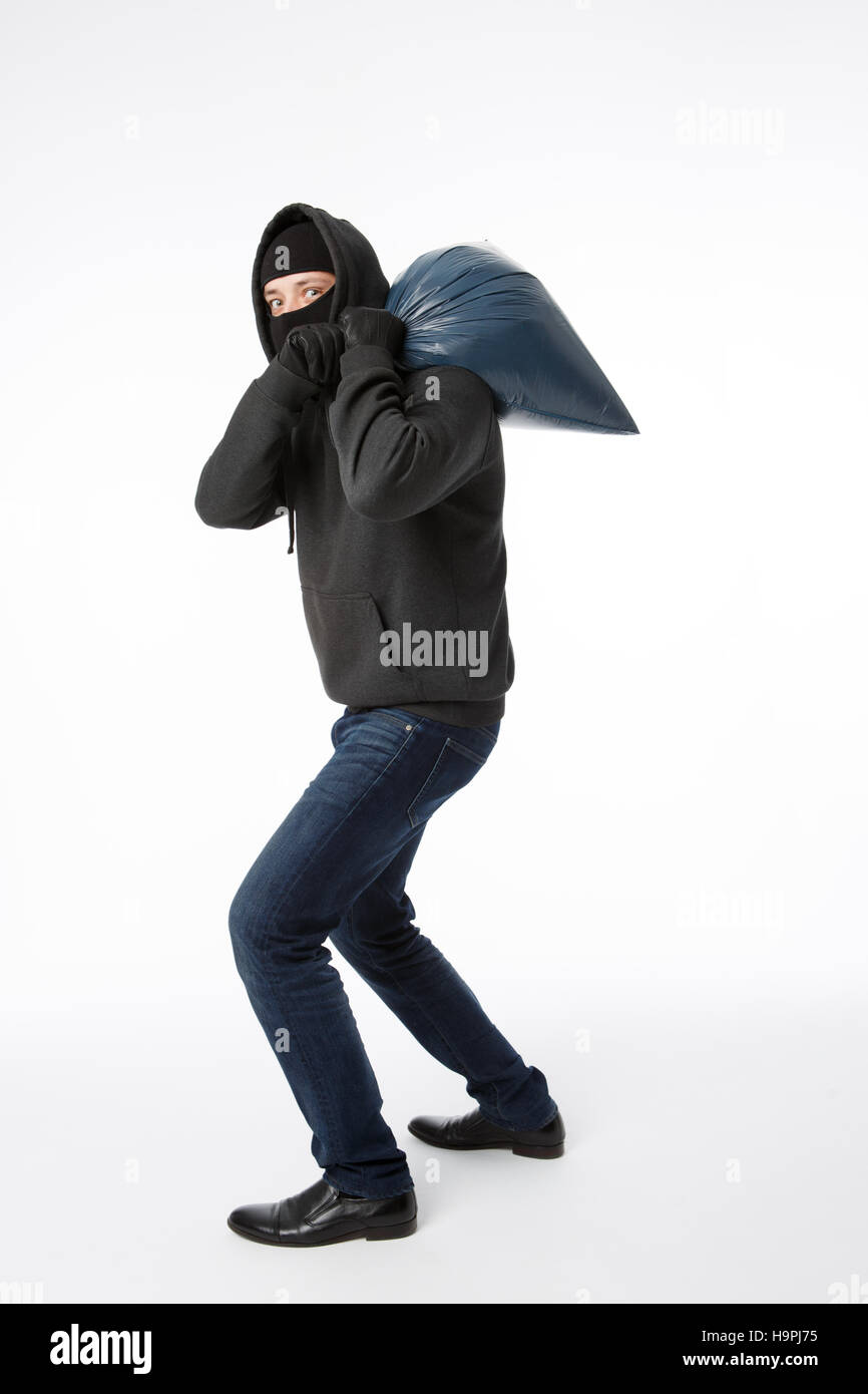 Thief with bag on shoulder Stock Photo Alamy